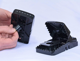 Large black rat snap trap with secure grip teeth and reusable design for effective rodent control